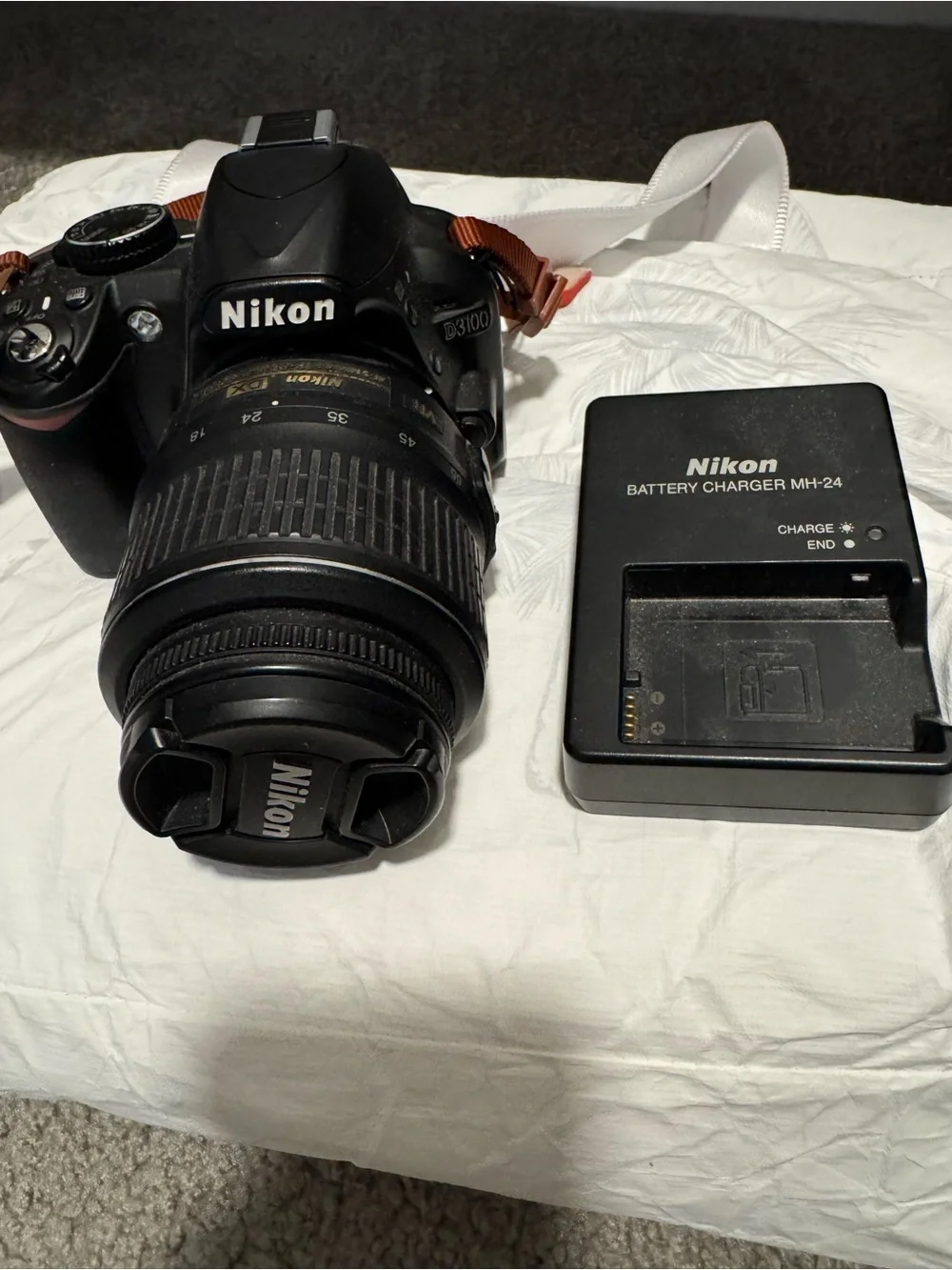 Nikon DSLR Camera with Black Lens and Black Charger